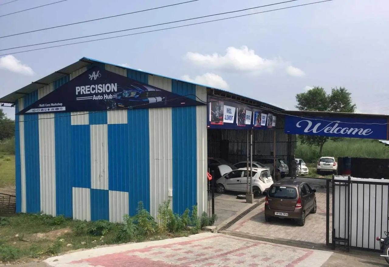 Precision Auto Hub workshop with its blue and white shopfront on the Una–Amb road